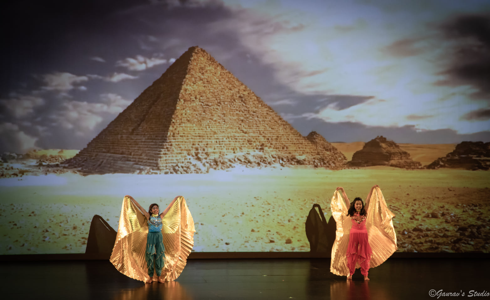 Dancers in gold costumes on stage